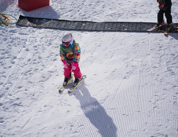 Little girl is skiing downhill. Ski resort in Alps, Austria, Zams on 22 Feb 2015 — Stock Photo, Image