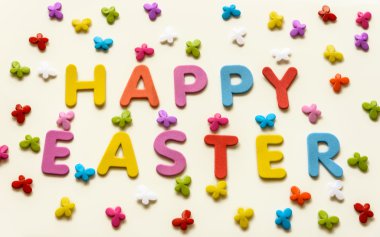 Text of colorful letters Happy Easter on the background of multicolored butterflies