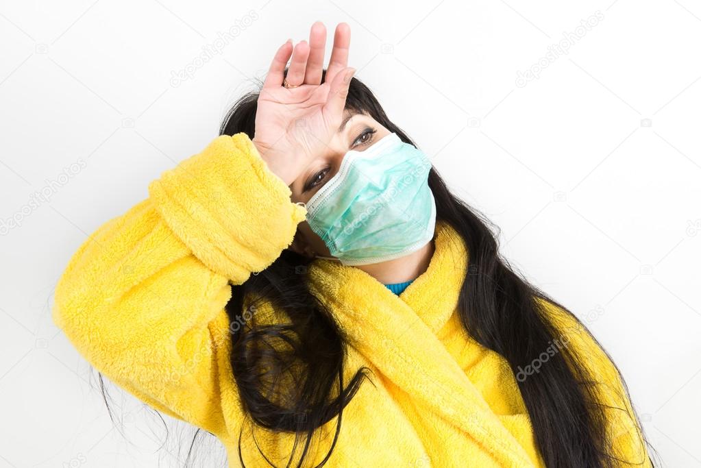 Symptoms and treatment of colds, influenza, fever. Treatment of allergy. A cold woman sneezing into a handkerchief on a white background.