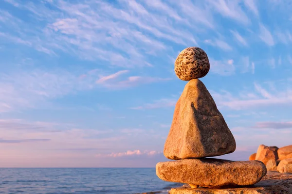 Concept of harmony and balance. Rock Zen at sunset