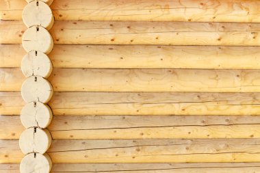 Modern, yeni, temiz, doğal renkten yuvarlak kütüklerden yapılmış kütük duvarı. Arkaplan resmi, doku