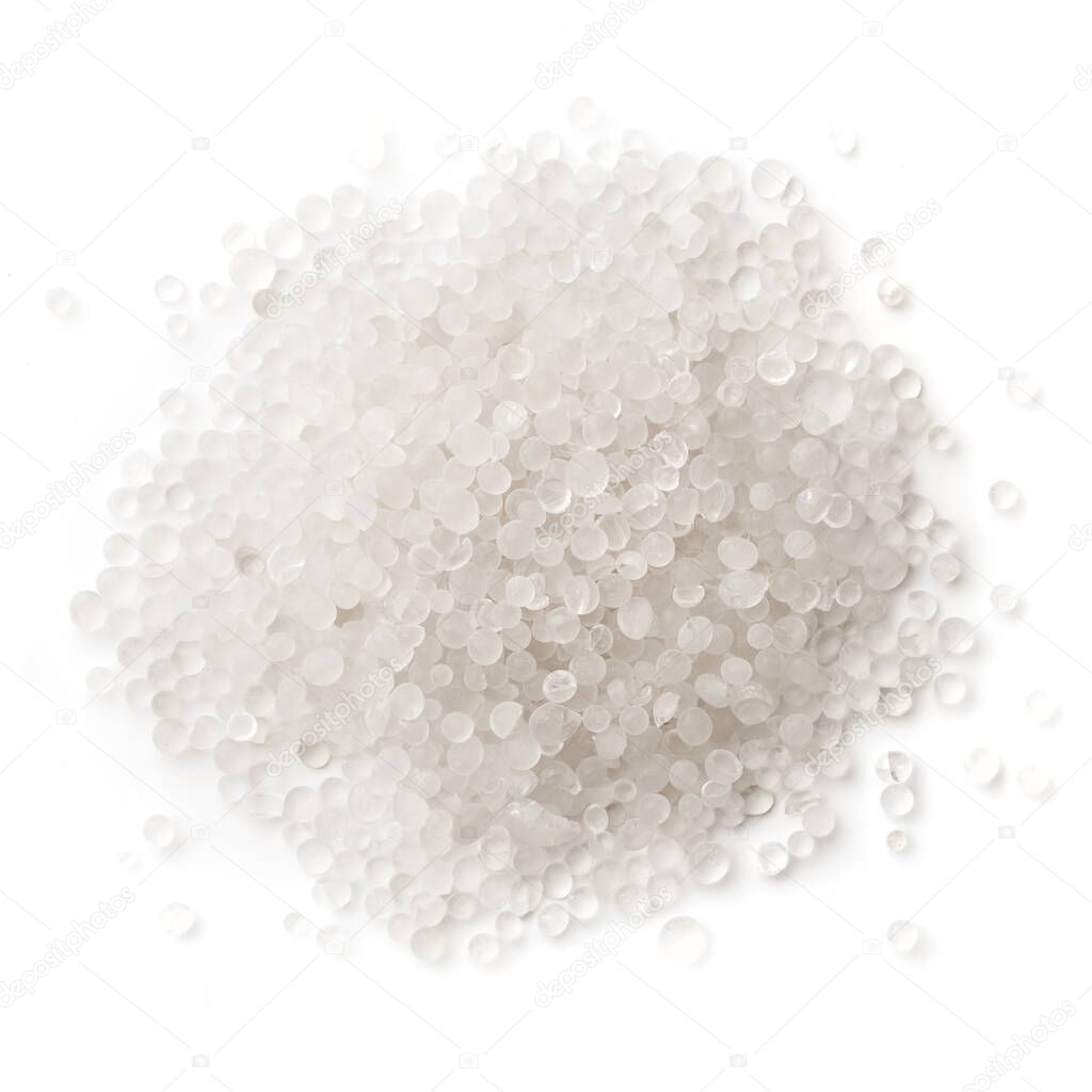 White plastic, polymer pellets for the production of plastic products. Close-up, isolated on a white background