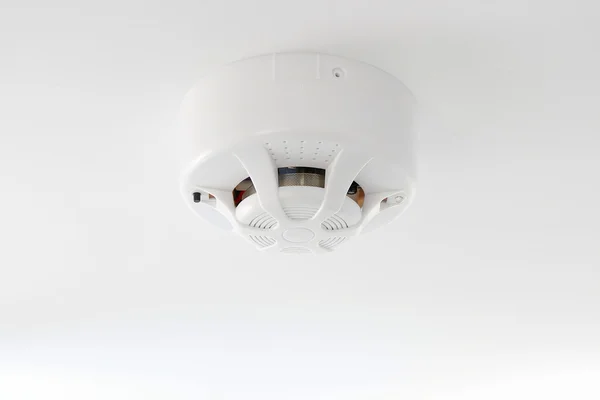 Smoke detector on white ceiling — 스톡 사진