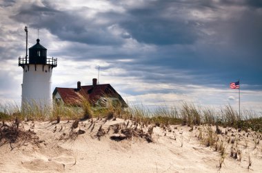 Flag Waves Next to Race Point Lighthouse Before Storm.