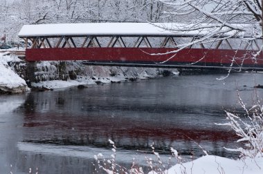 Red Covered Bridge in New England Snowstorm