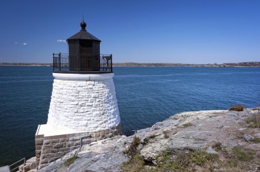 Stone Lighthouse Tower Overlooks Bay clipart