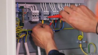 Elektrik telleri bağlarken fabrika işçisi