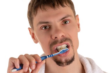 man cleaning his teeth with toothbrush