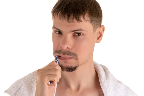 man cleaning his teeth with toothbrush