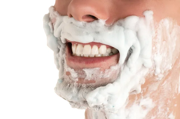 Parte inferiore del viso in schiuma da barba uomo con barba denti ghigno — Foto Stock