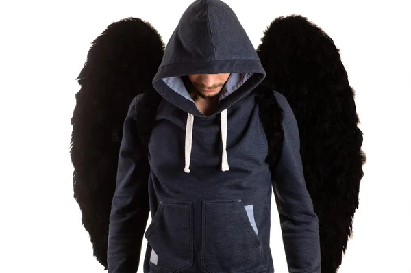 elleri sırtında ve siyah kanatlarıyla ayakta duran adam