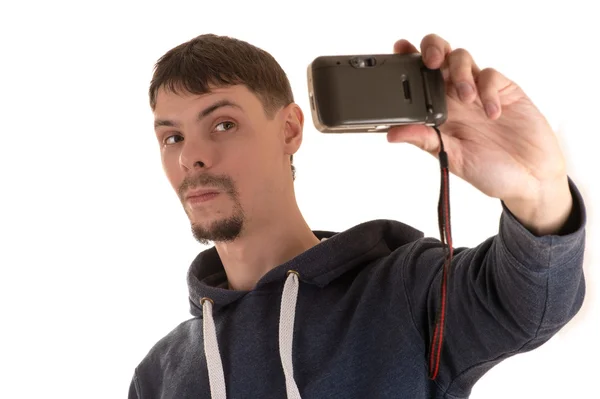 Young man holding with his left hand and takes pictures old camera itself — Stock Photo, Image