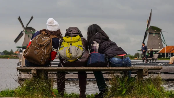 Female Backpackers in front of traditional dutch windmills (October 2015 - s-Hertogenbosch, Brabant, Netherlands)
