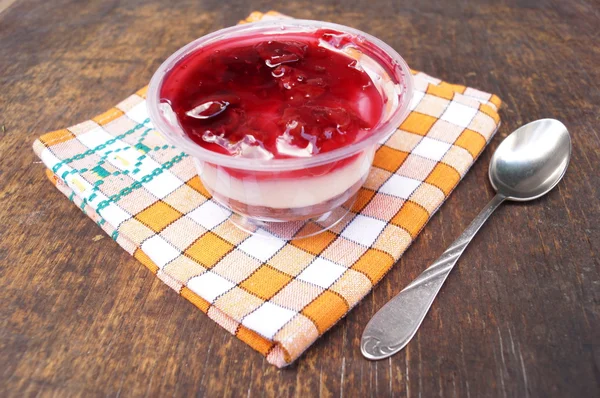 Parfait dessert with berries, milk souffle and jello layers. Treat in a glass on a rustic wooden background — Stock Photo, Image