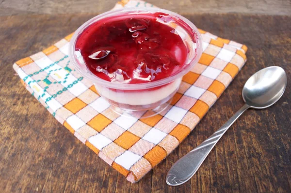 Parfait dessert with berries, milk souffle and jello layers. Treat in a glass on a rustic wooden background — Stock Photo, Image