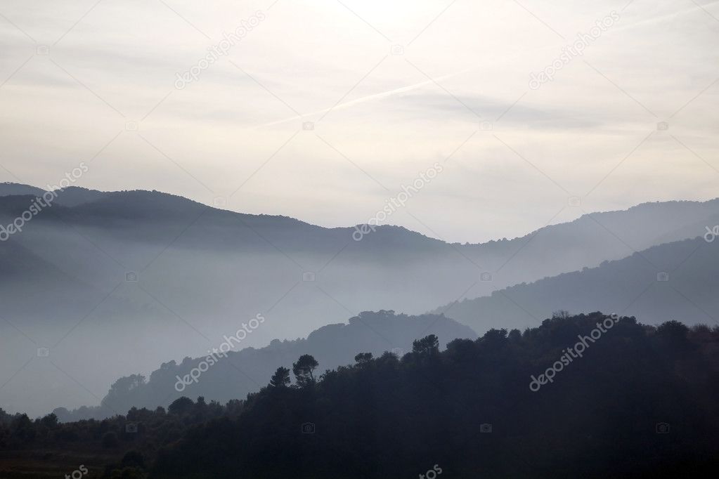 Foggy mountains in a winter morning