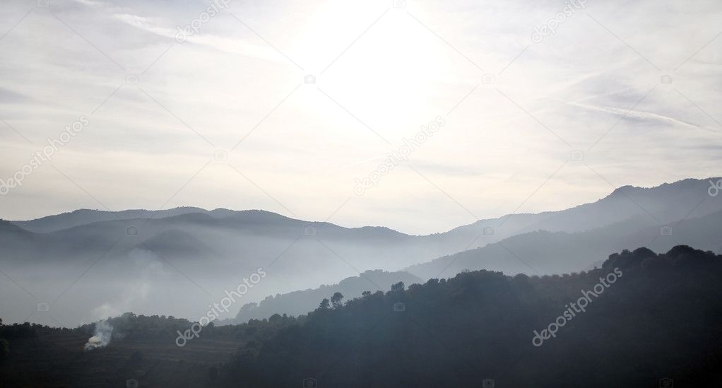 Foggy mountains in a winter morning