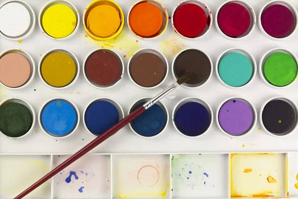 Watercolor palette with paintbrush — Stock Photo, Image