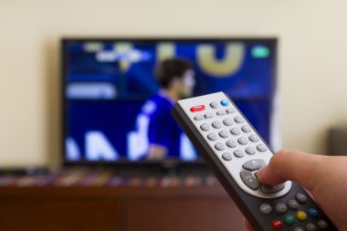 Television remote control in human hands clipart