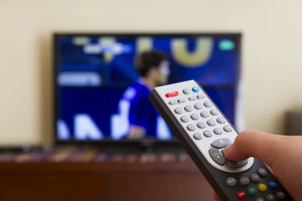 Television remote control in human hands — Stock Photo, Image