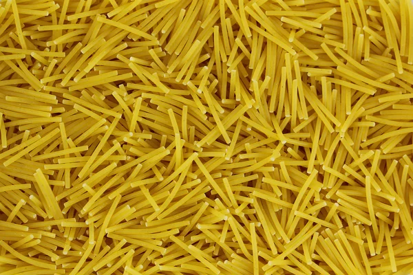 Raw vermicelli pasta background, macro shot — Stock Photo, Image