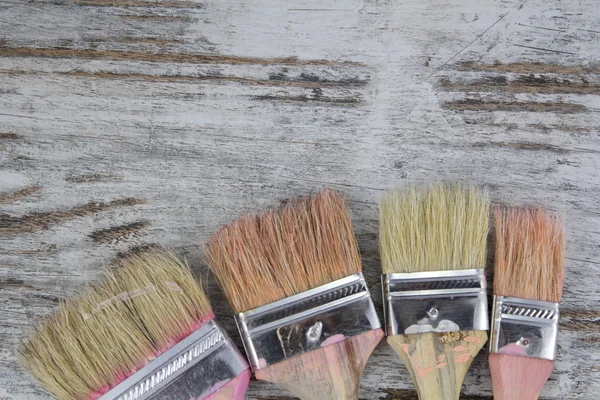 Set of paintbrushes in a wood background — Stock Photo, Image