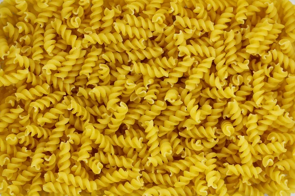 Raw fusilli pasta, golden macaroni — Stock Photo, Image