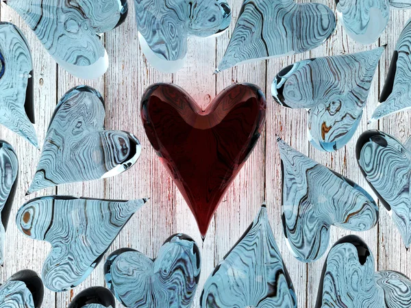 Червоне скляне серце серед синіх скляних сердець — стокове фото