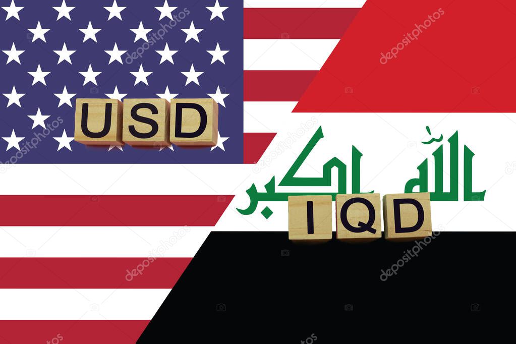 USA and Iraq currencies codes on national flags background. International money transfer concept