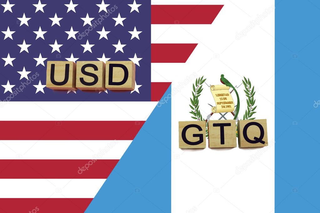 USA and Guatemala currencies codes on national flags background. International money transfer concept