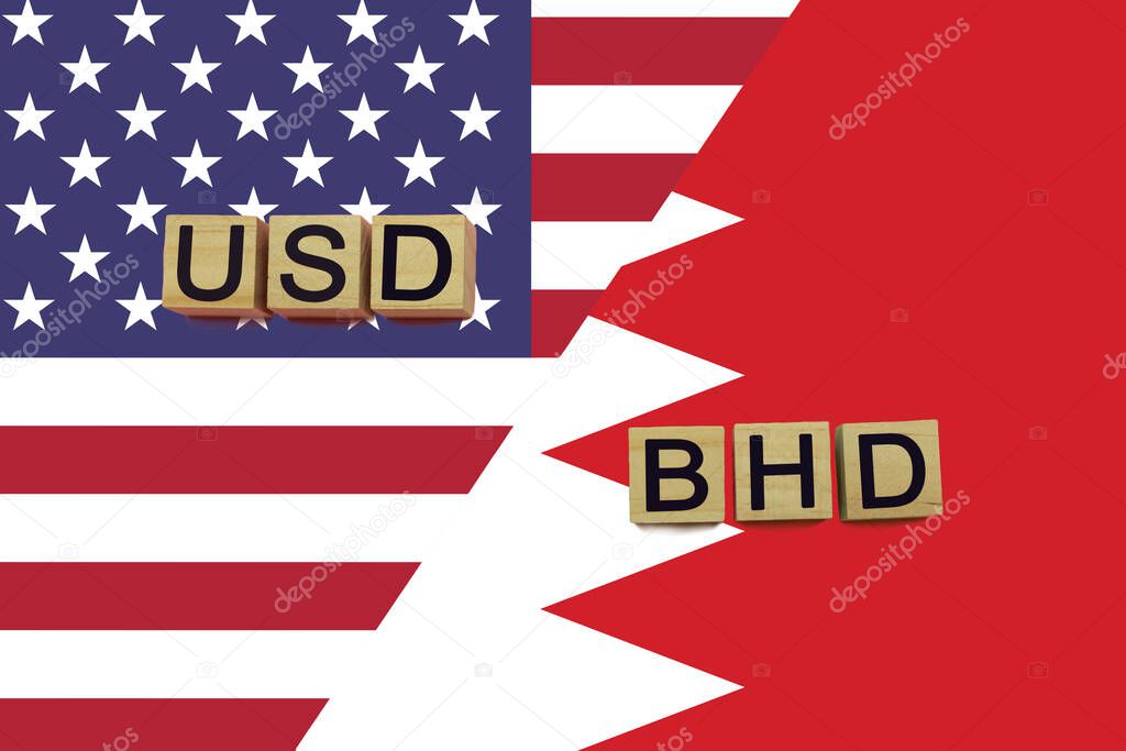 USA and Bahrain currencies codes on national flags background. International money transfer concept