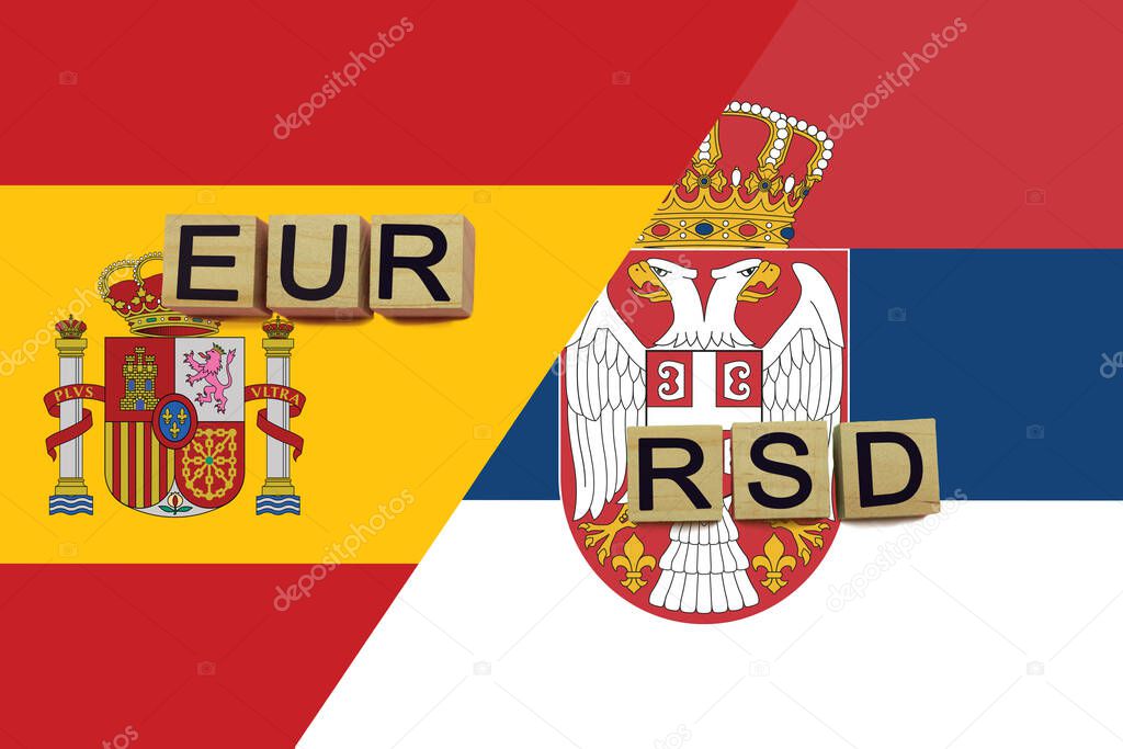 Spain and Serbia currencies codes on national flags background. International money transfer concept
