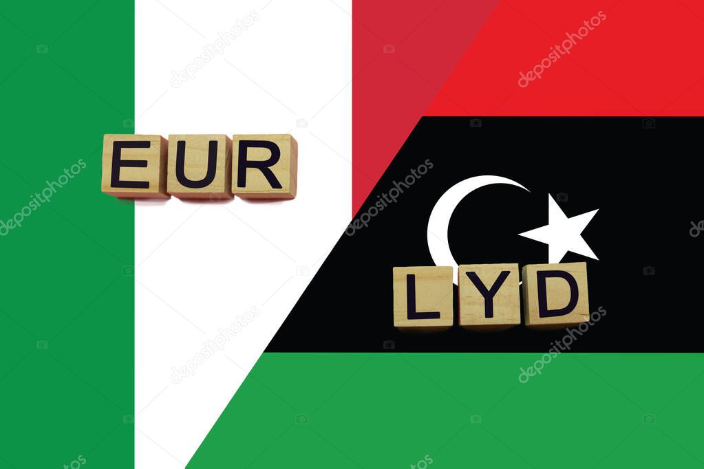 Italy and Libya currencies codes on national flags background. International money transfer concept