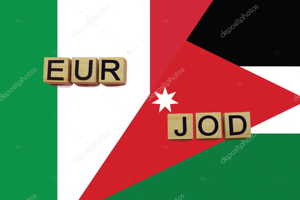 Italy and Jordan currencies codes on national flags background. International money transfer concept