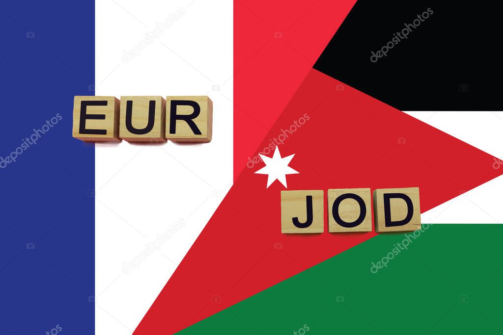 France and Jordan currencies codes on national flags background. International money transfer concept
