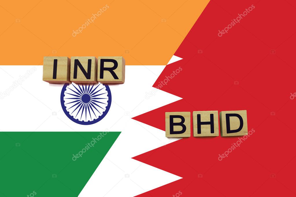 India and Bahrain currencies codes on national flags background. International money transfer concept