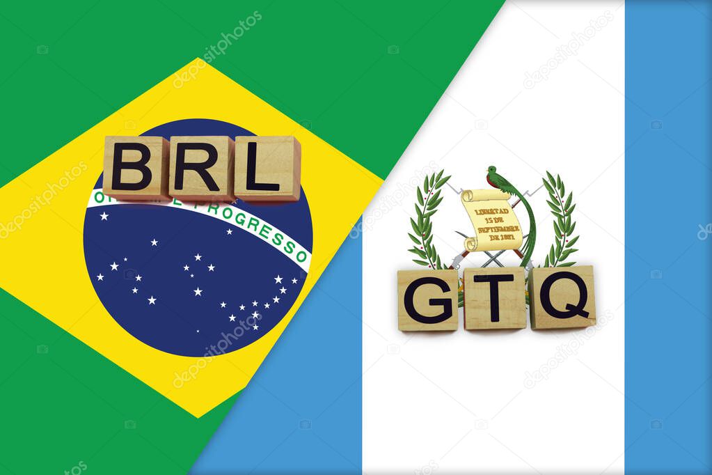 Brazil and Guatemala currencies codes on national flags background. International money transfer concept