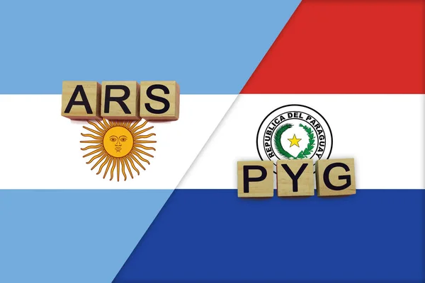 Argentina and Paraguay currencies codes on national flags background. International money transfer concept