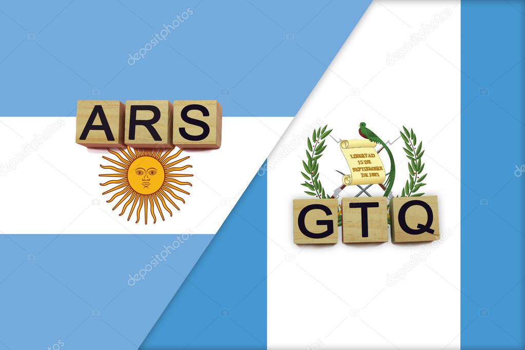 Argentina and Guatemala currencies codes on national flags background. International money transfer concept