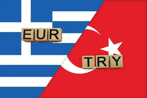 Greece and Turkey currencies codes on national flags background. International money transfer concept