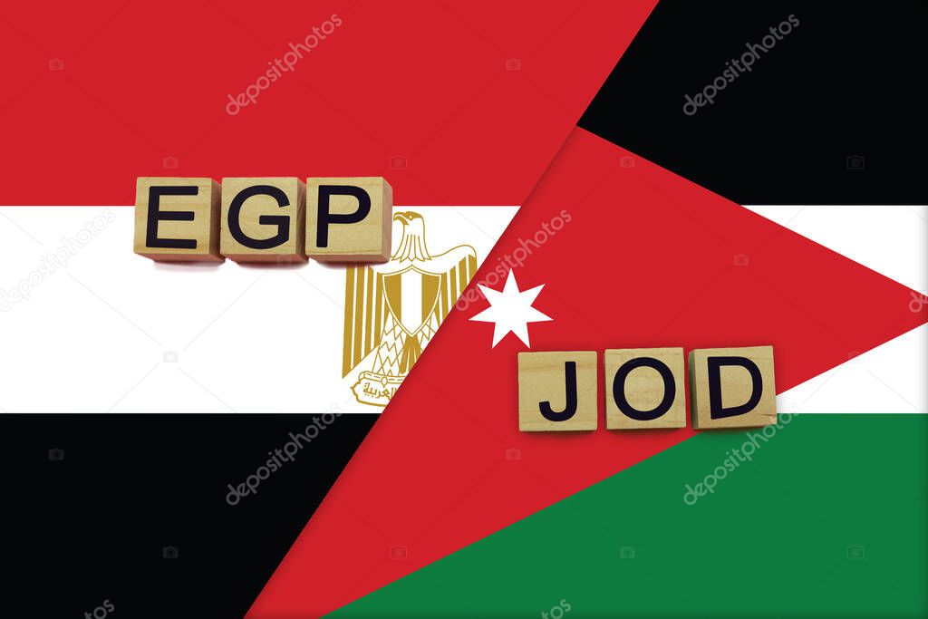 Egypt and Jordan currencies codes on national flags background. International money transfer concept