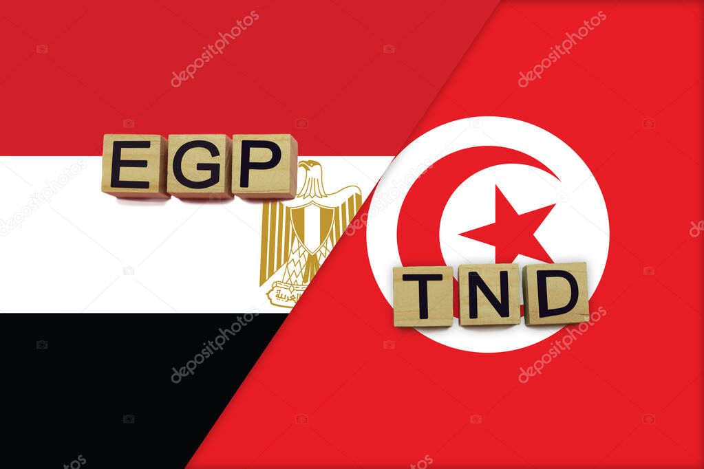 Egypt and Tunisia currencies codes on national flags background. International money transfer concept