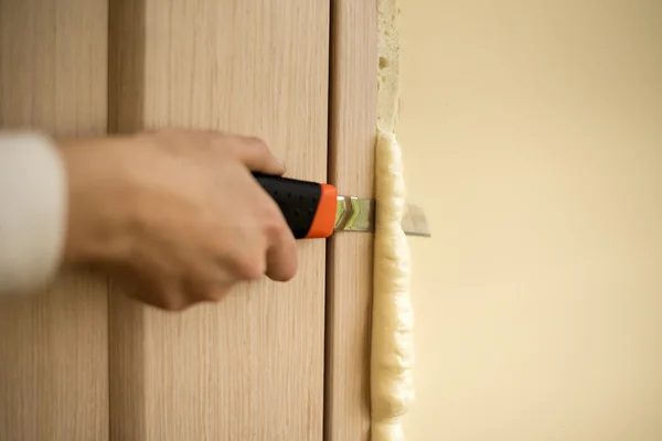 Master knife cuts polyurethane foam — Stock Image Master knife cuts polyurethane foam Stock Picture