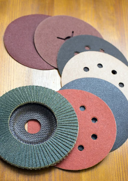 Abrasive materials - sheets of sandpaper and disks close-up