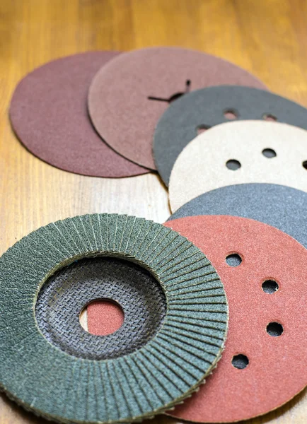 Abrasive materials - sheets of sandpaper and disks close-up