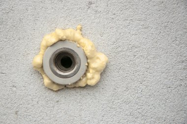 polyurethane foam filled pipe in the wall   clipart
