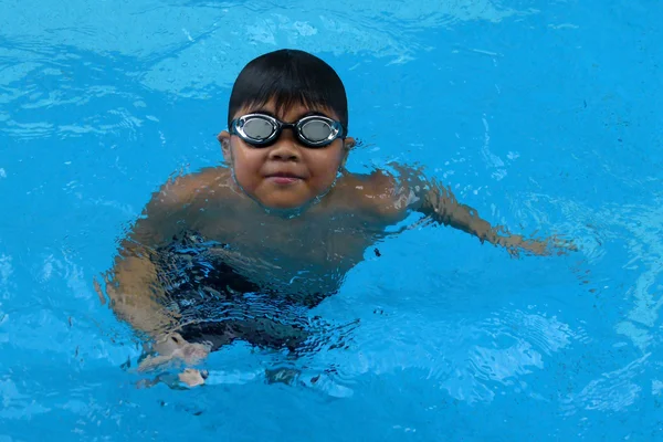 Happy boy stand in the swimming pool - front crawl style with scissor kick — Stok fotoğraf