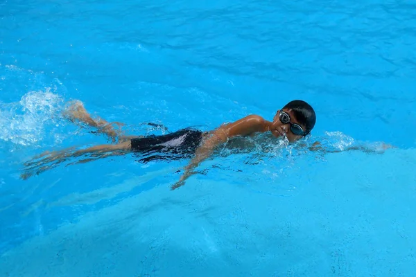 Happy Boy swim in the swimming pool - front crawl style with scissor kick Telifsiz Stok Fotoğraflar