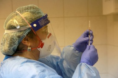 BUCHAREST, ROMANIA - 27 Aralık 2020: Bir hemşire Avrupa Aşı Kampanyasının ilk gününde bir doz Pfizer-BioNTech COVID-19 aşısı hazırladı.
