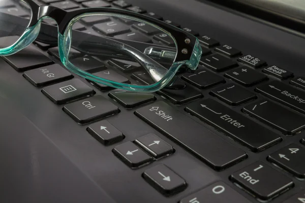 ラップトップ コンピューターのキーボードと眼鏡のクローズ アップ — ストック写真